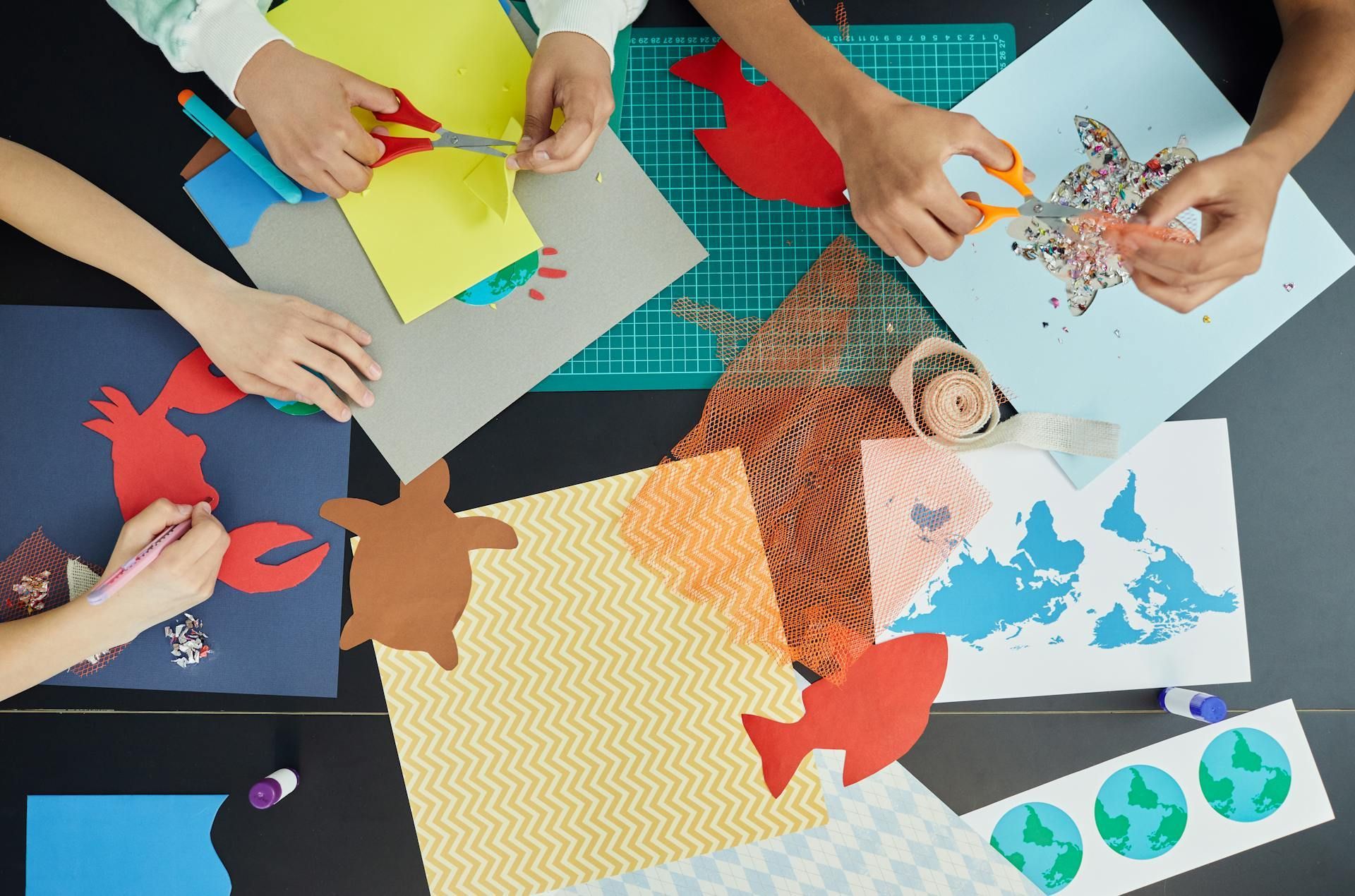 close-up of hands cutting paper shapes